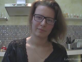 Solo lady with glasses chatting in the kitchen